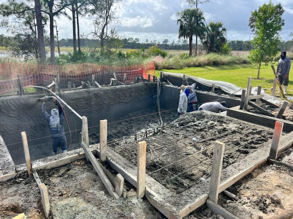 A group of people are working on a swimming pool.