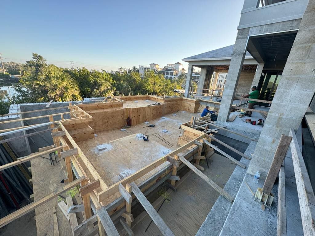 A large building under construction with a lot of wooden beams.