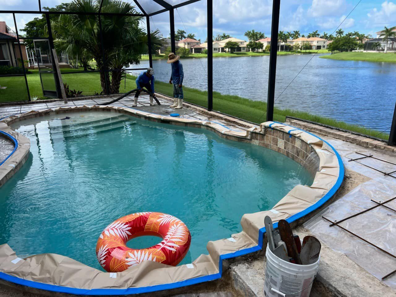 A swimming pool is being painted with a life preserver in it.
