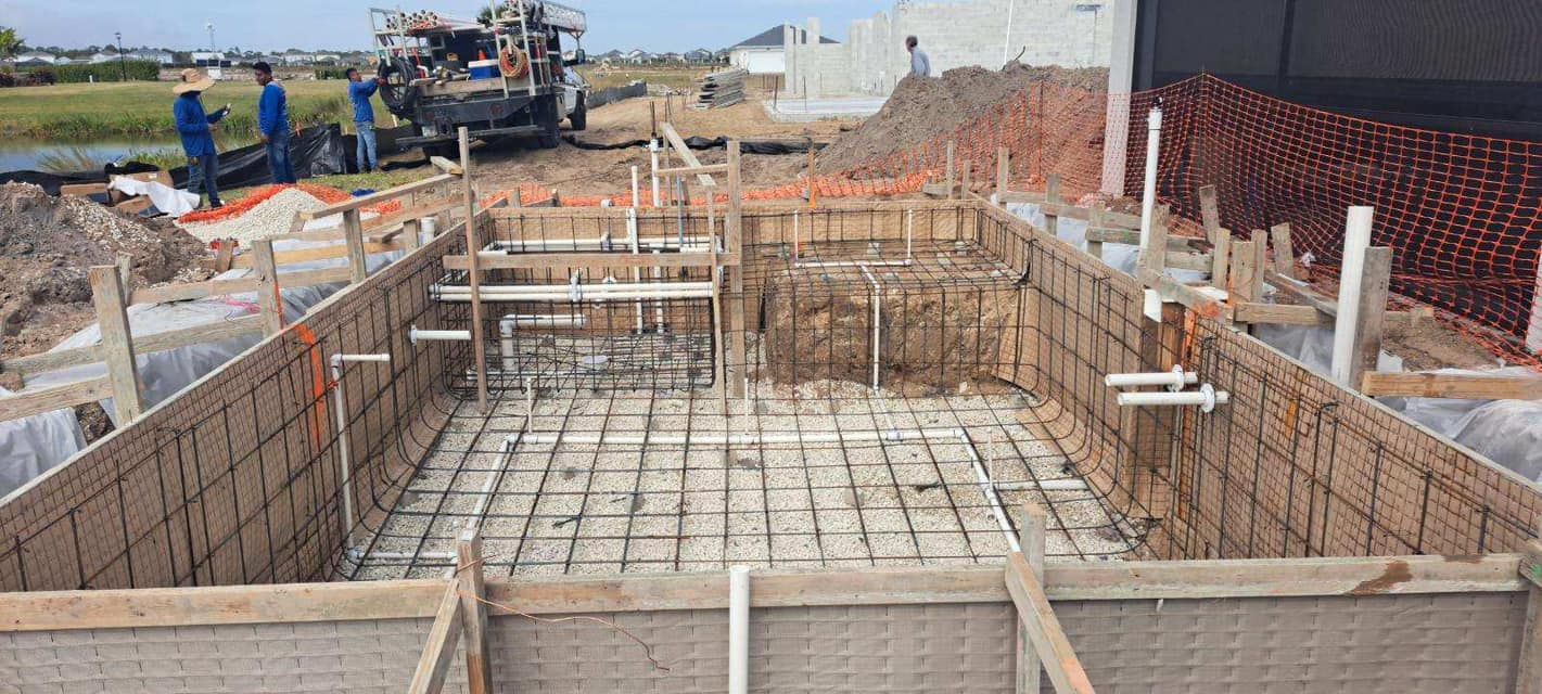 A large swimming pool is being built on a construction site.