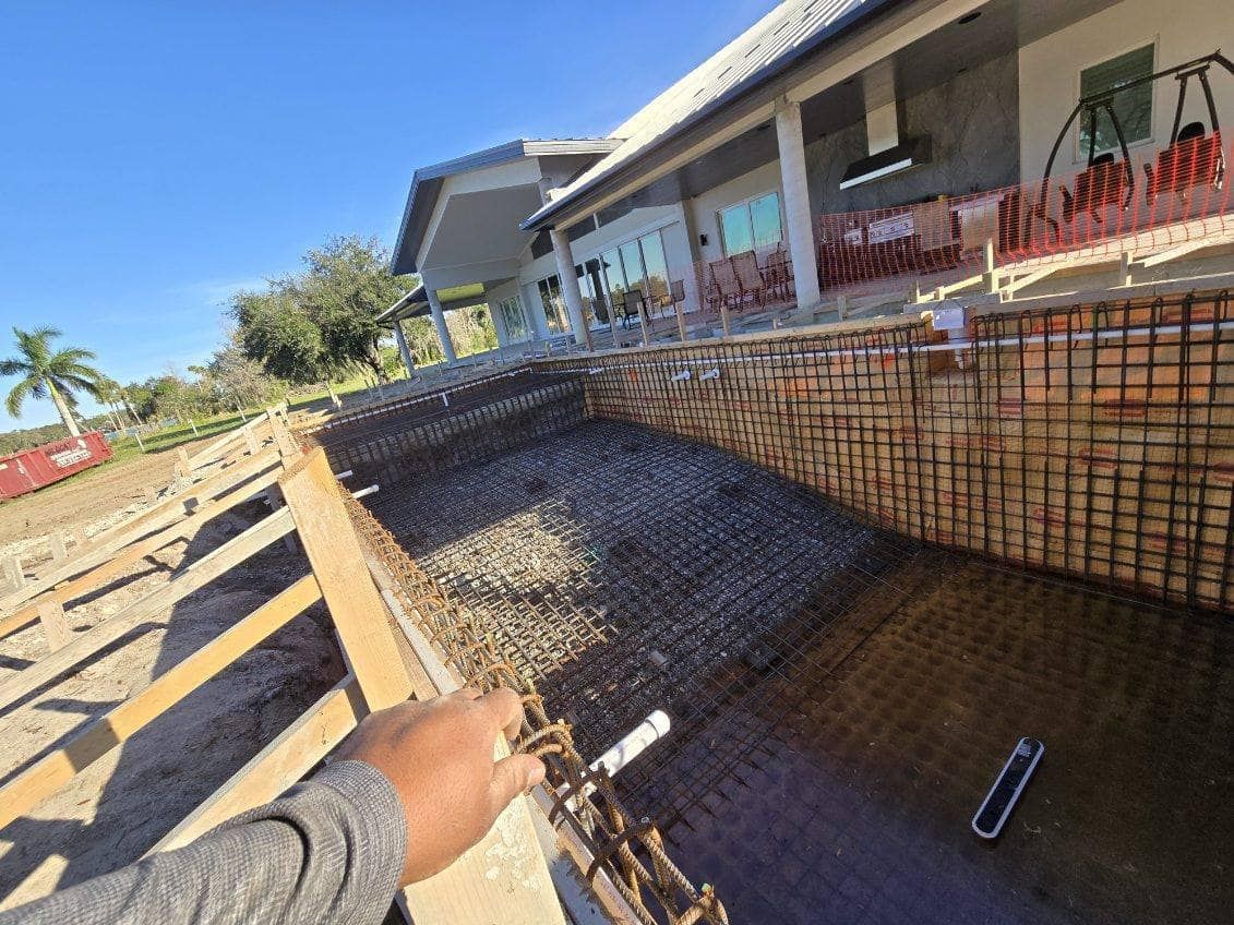 A person is standing in front of a building under construction.
