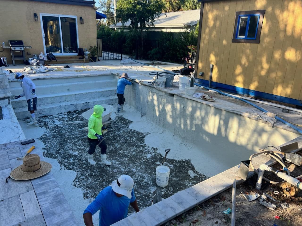 A group of people are working on a swimming pool.