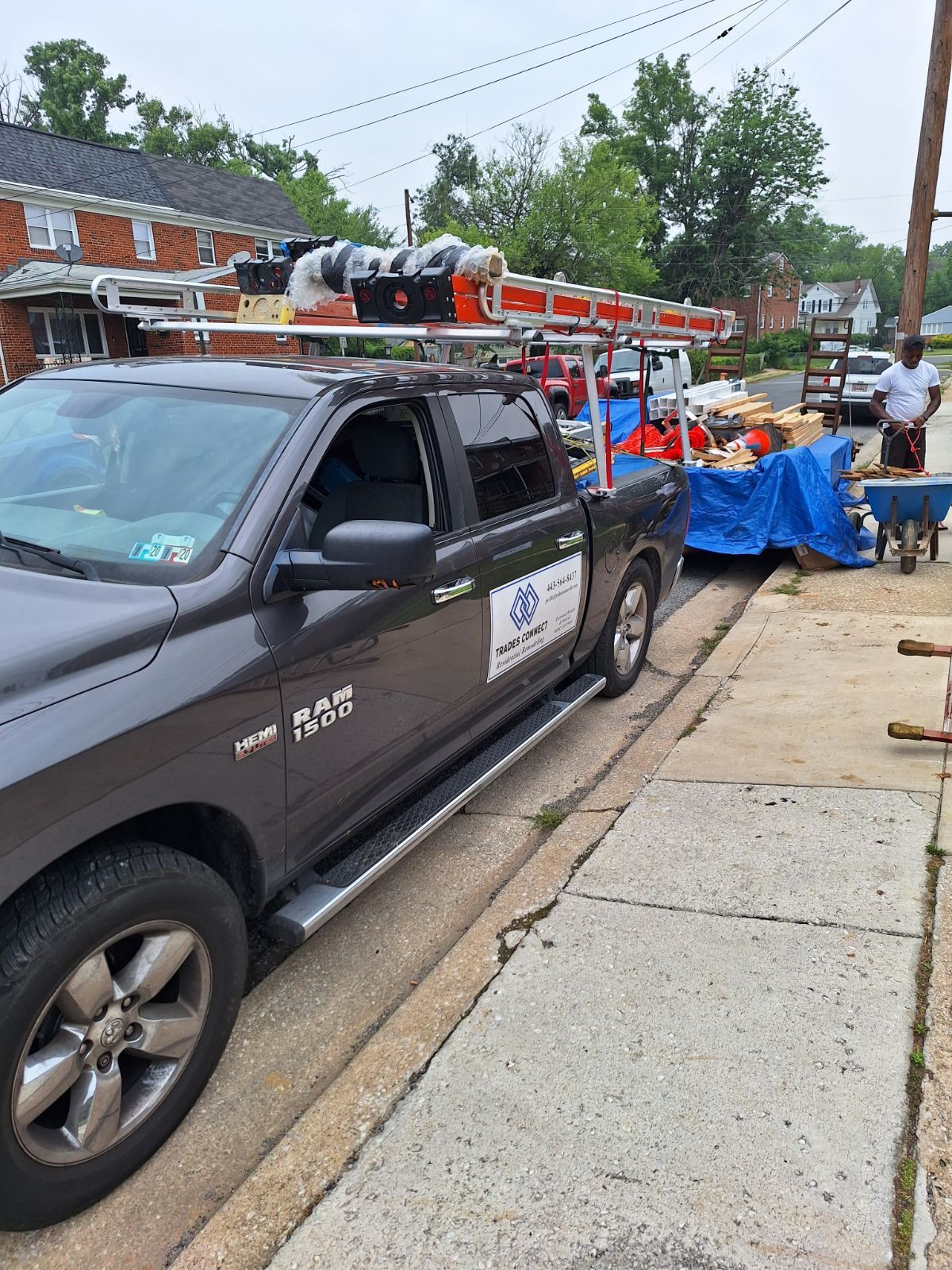 a black truck is parked on the side of the road .