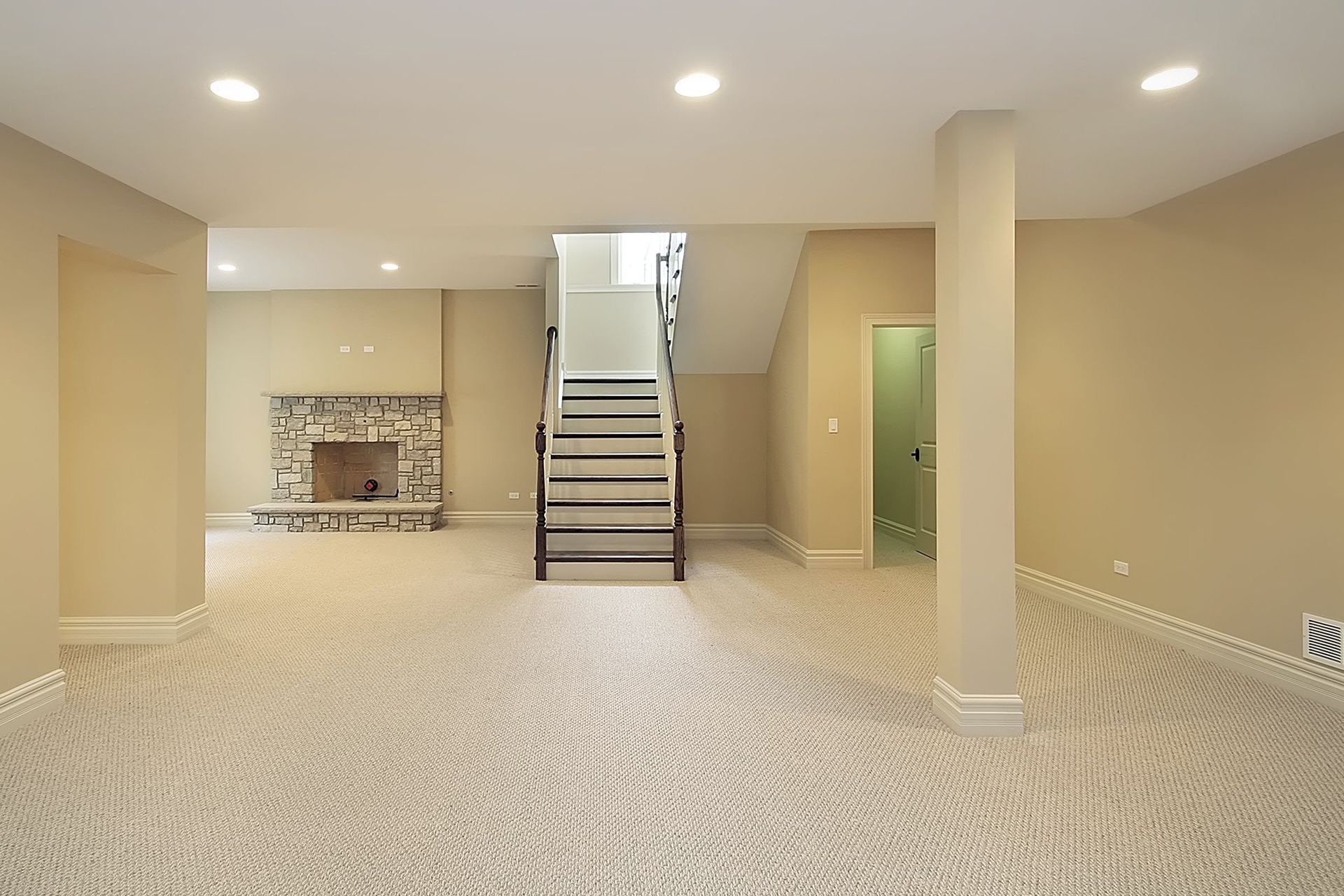 a house with a large deck and stairs leading up to it .