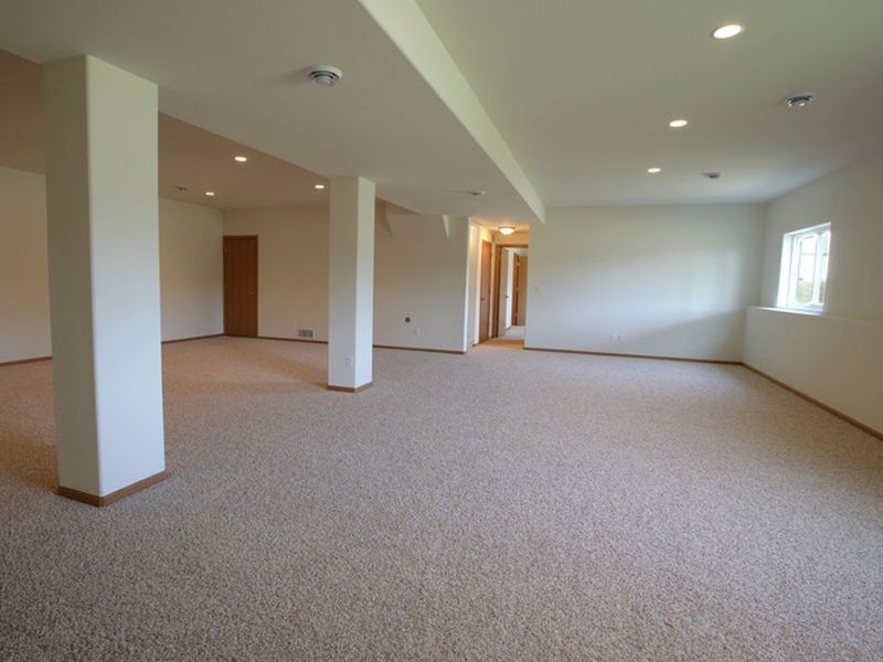 a bathroom with a tub , shower , sink and window .