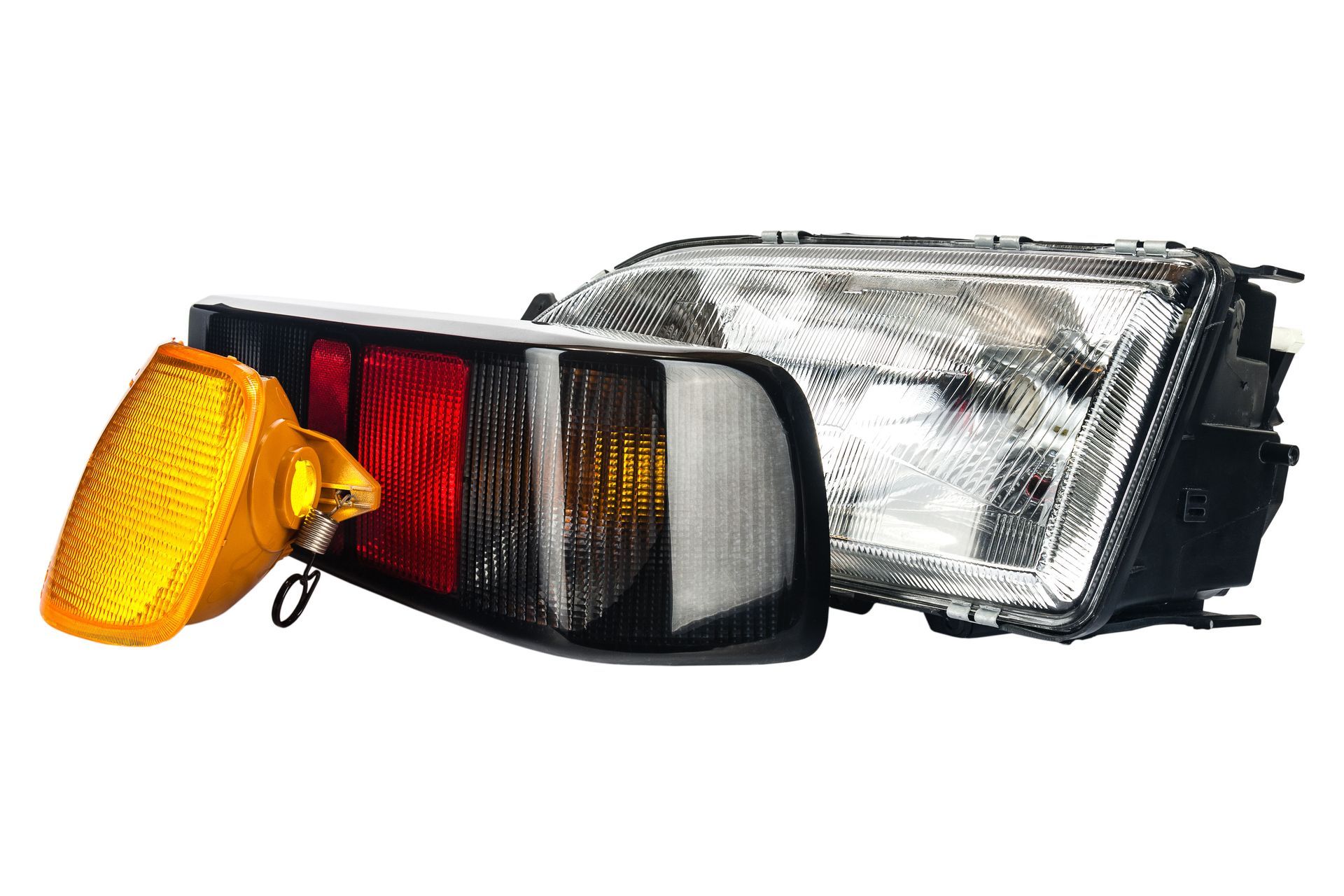 Automotive headlight assembly with amber turn signal and clear lens on white background