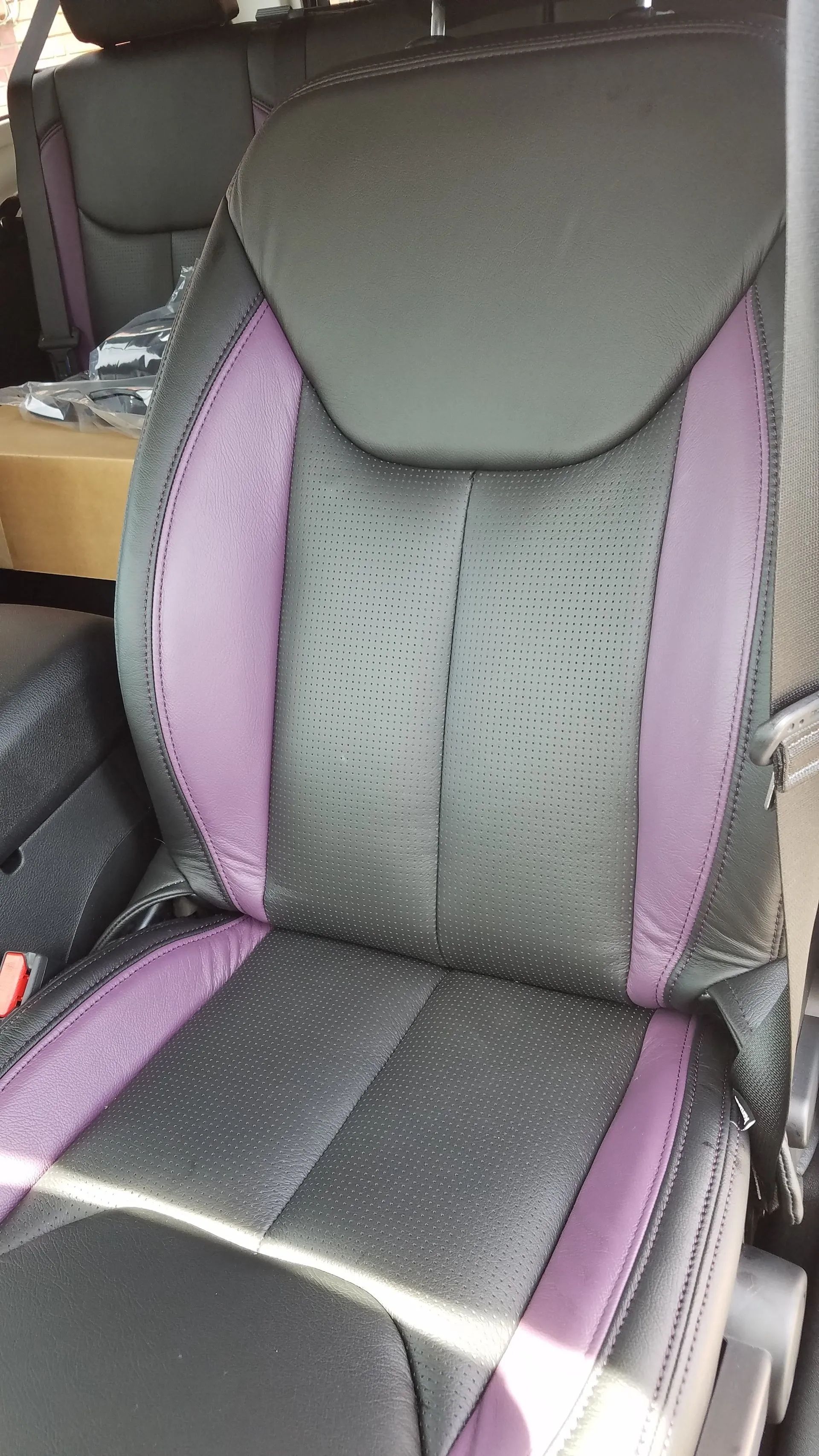 Gray and purple car seat with black accents and stitched center panel