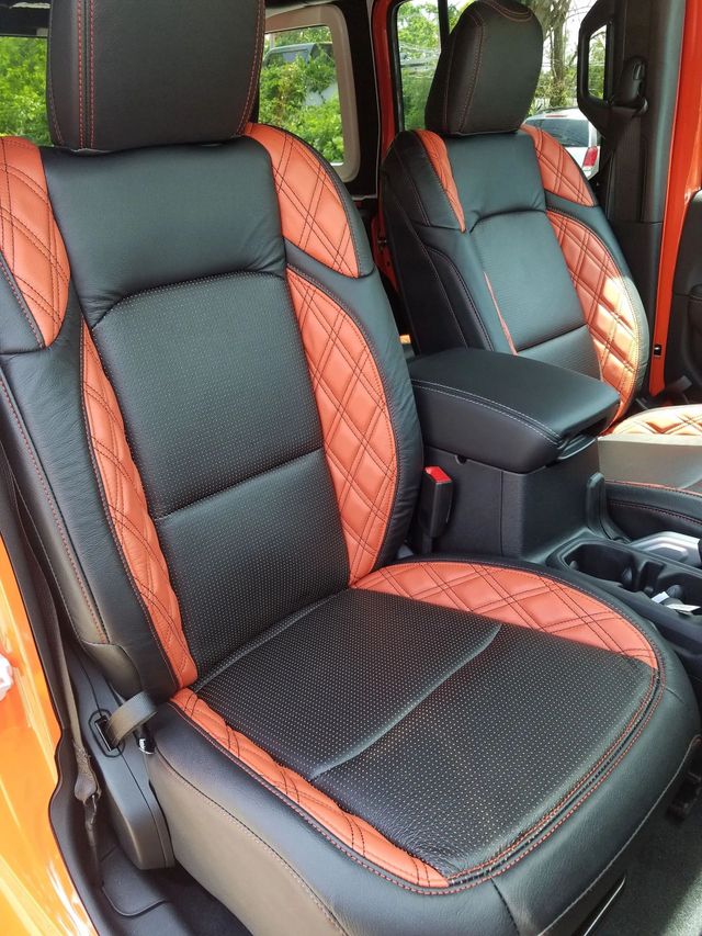 Black and orange patterned car seats with matching headrests and center console