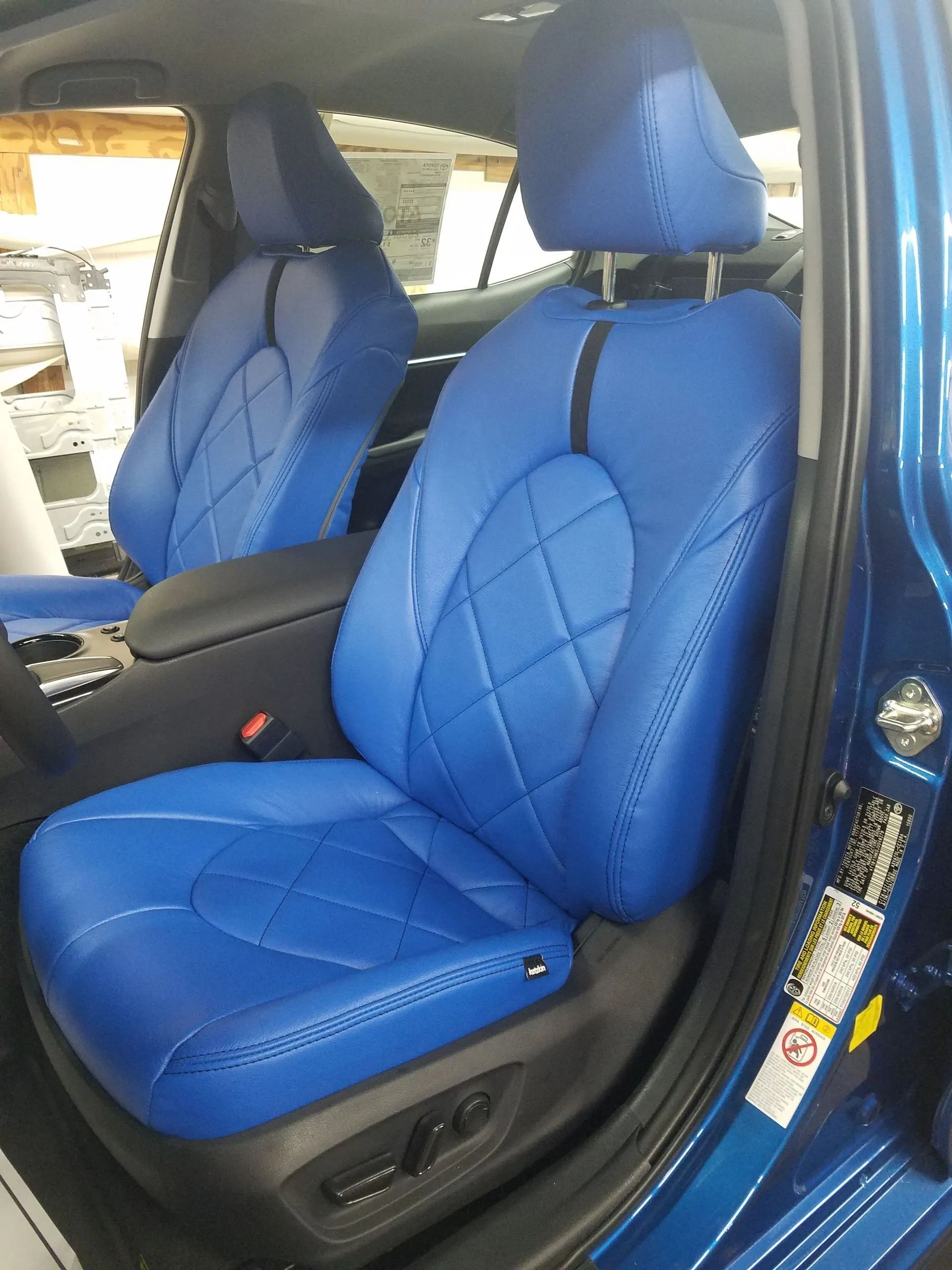 Blue car seats with diamond-stitched covers in a vehicle interior
