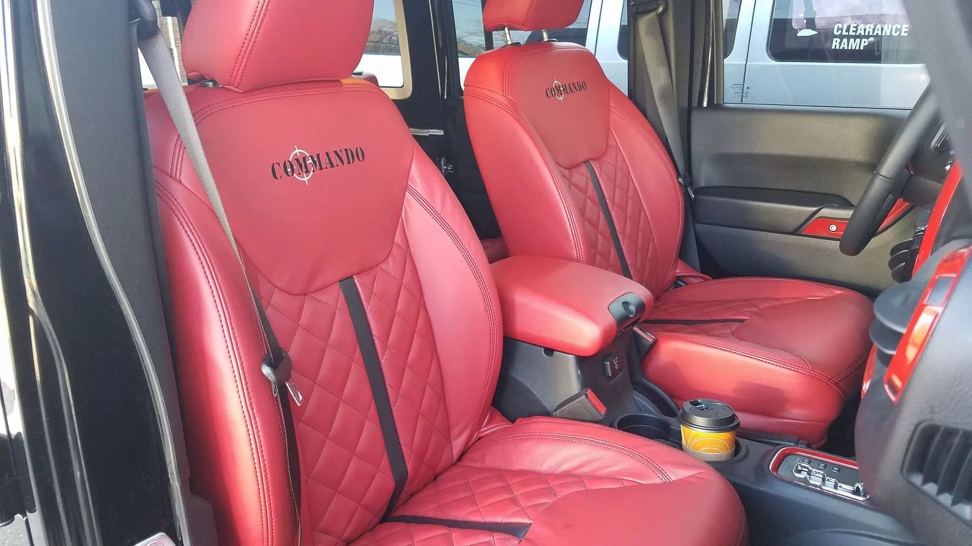 Red leather car seats and interior with black accents, shown from the rear passenger side.