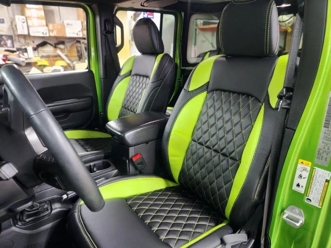 Bright green and black quilted car seats and matching interior in a vehicle cabin
