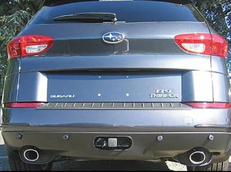 Rear view of a blue Subaru Tribeca SUV with dual exhaust pipes and rear badges.