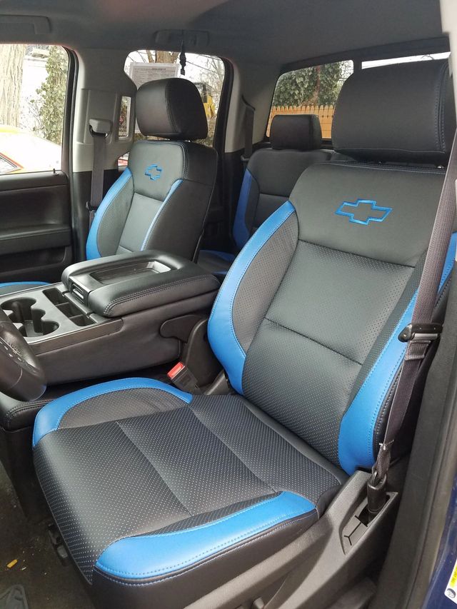 Car interior with black and blue bucket seats and a center console