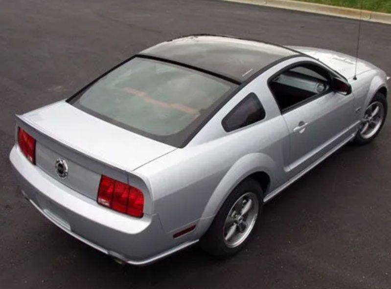 Silver two-door sports coupe viewed from above on a road