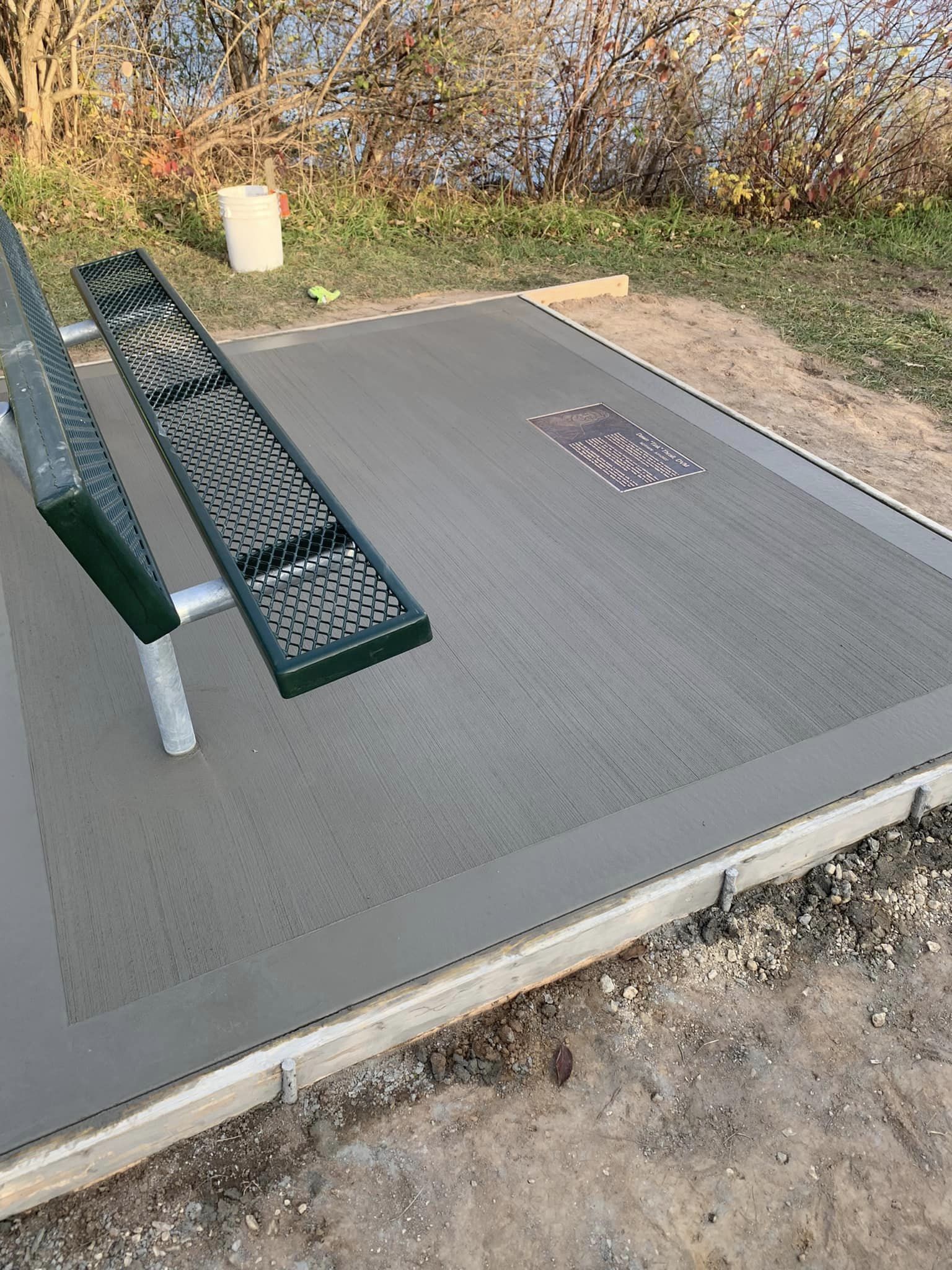 Concrete flooring with metal bench