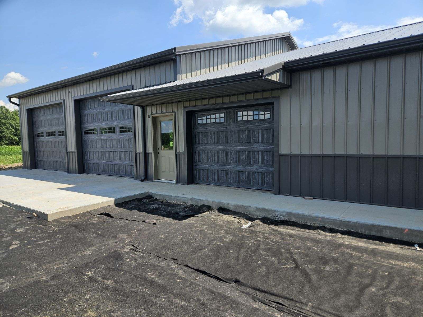 A large building with a lot of garage doors is being built.