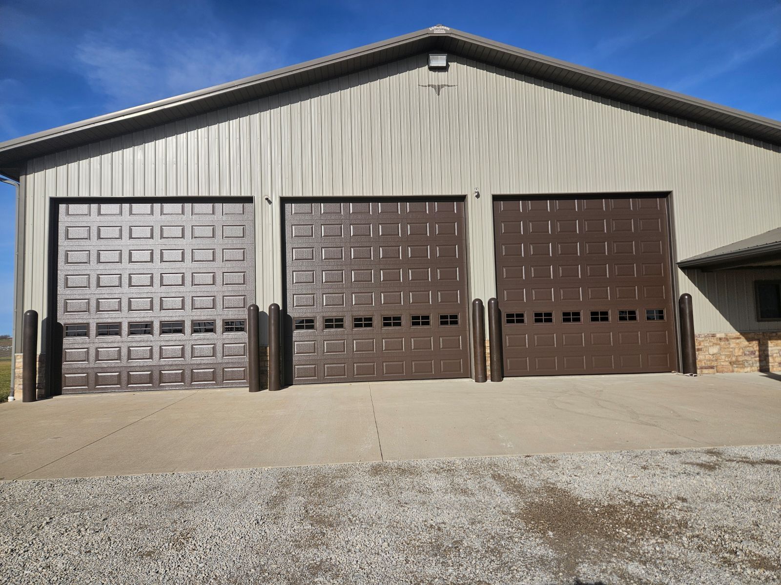 A large building with three garage doors on it