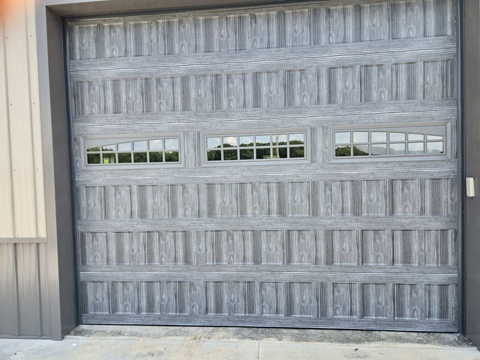 A gray garage door with a lot of windows on it.