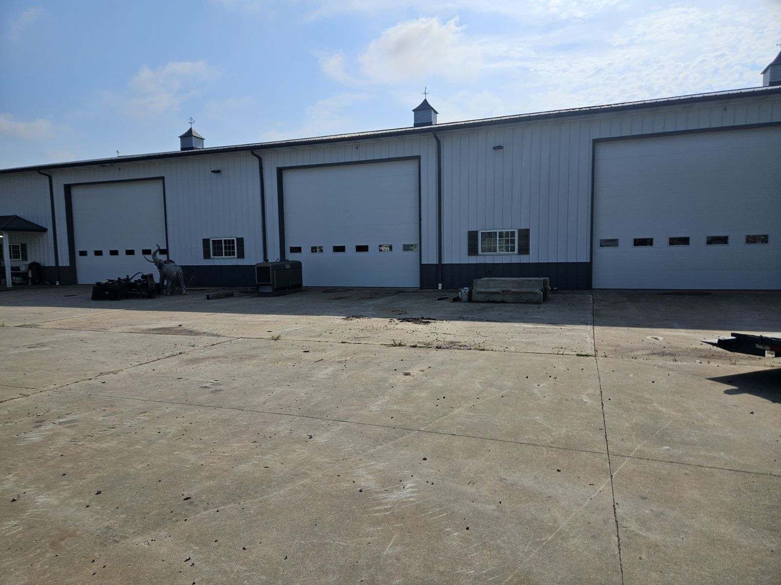 A large white building with a lot of garage doors