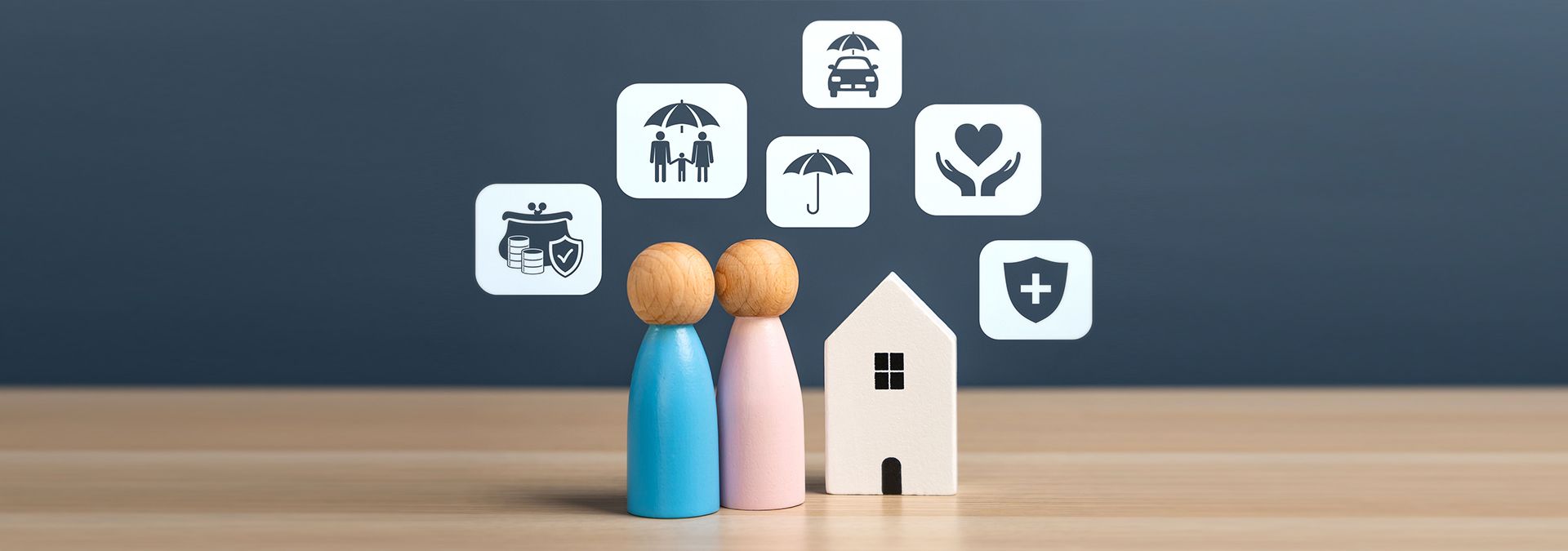 Wooden figures of a couple and a house with icons.