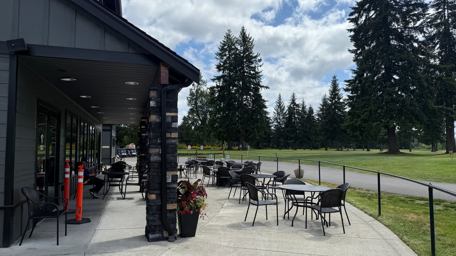 A patio with tables and chairs in front of a building