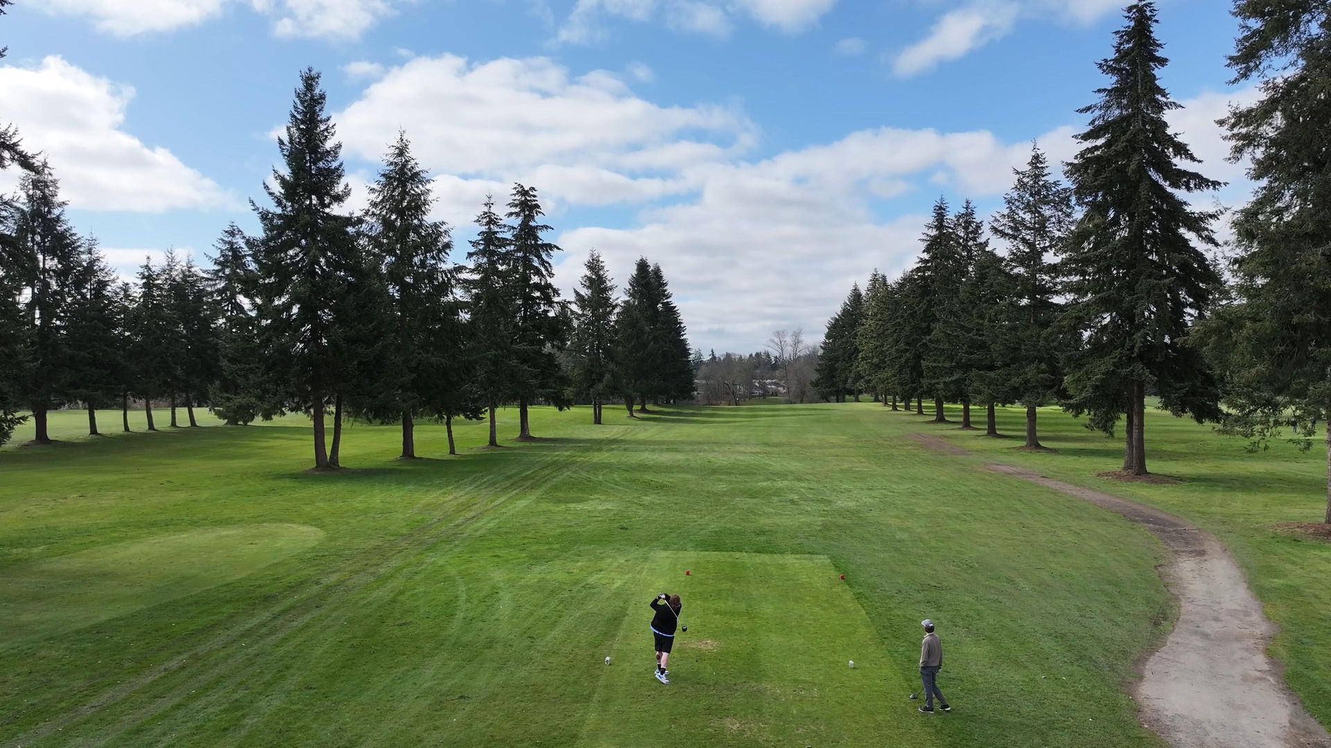 Two men playing golf