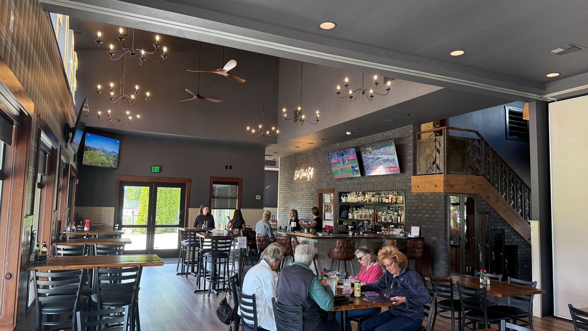 A group of people are sitting at tables in a restaurant