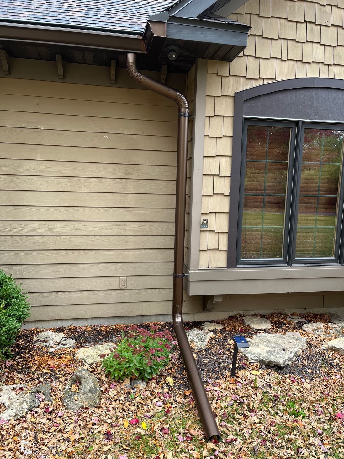 A house with a window and a gutter on the side