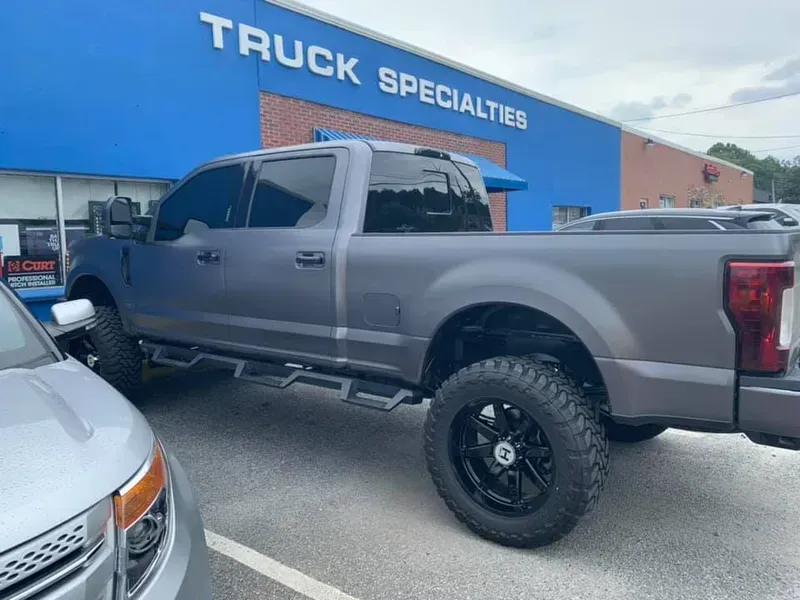 Gray lifted truck parked outside