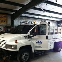 White CSX truck parked inside a building.