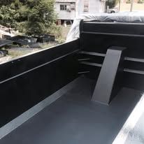 Black truck bed interior with a support beam.