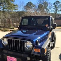 Blue Jeep parked outdoors.