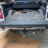 Truck bed with a hitch and toolbox.