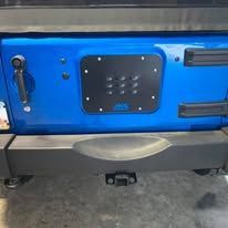 Blue Jeep rear bumper with a black license plate mount.