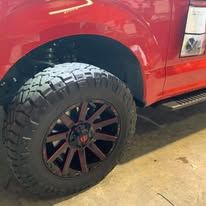 Red truck tire and wheel with dark red accents.