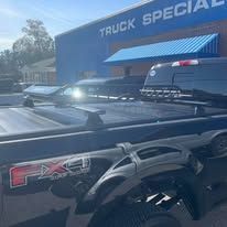 Truck with truck bed cover parked in front of a