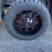 Black and red custom truck wheel and tire.