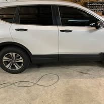 White SUV parked on a concrete surface with tinted windows.