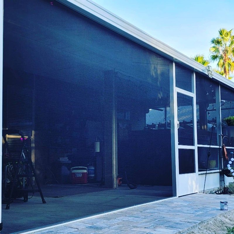 A screened in porch with a white door