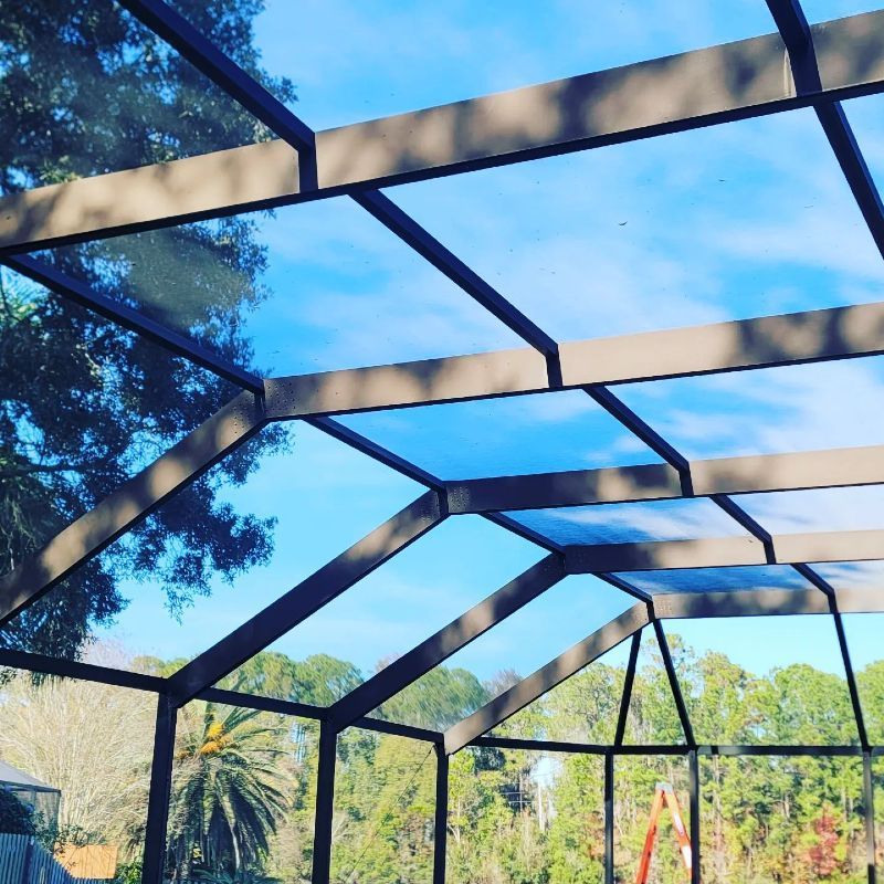 A screened in area with a blue sky in the background