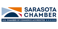 Sarasota Chamber logo with blue and orange sail icon and U.S. Chamber of Commerce Accredited badge