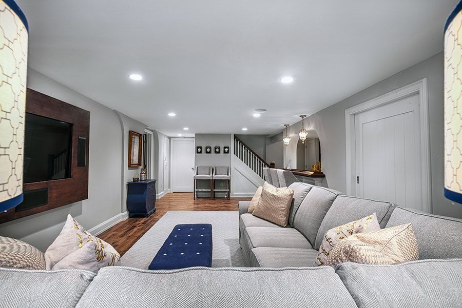 A modern living room with a sectional sofa, media center, and bar area.