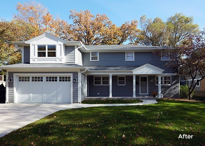 Gray house with white trim and garage door, on a sunny day.