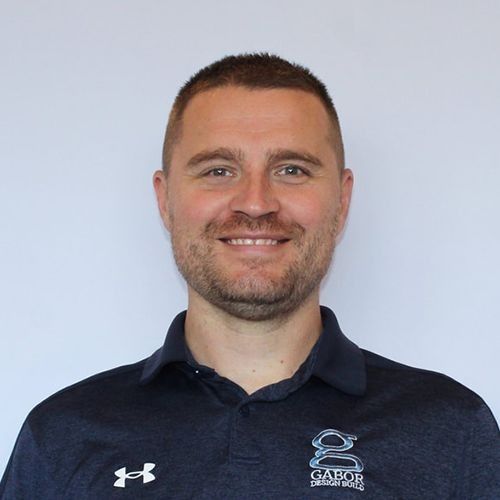 Bryan smiling, wearing a navy polo shirt with 