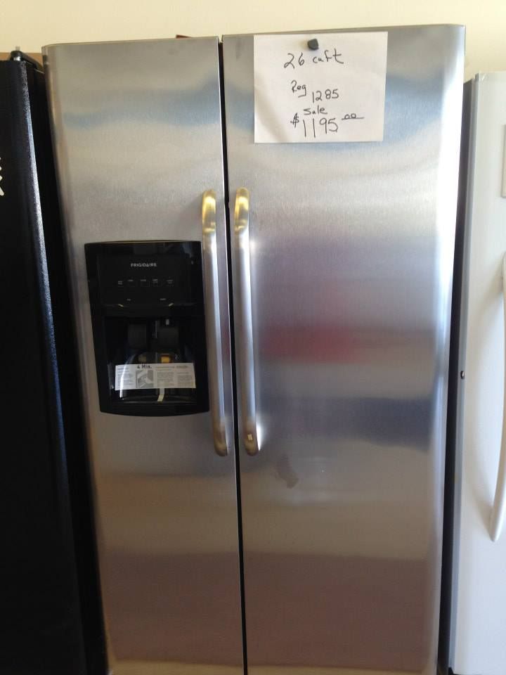 A stainless steel refrigerator with a price tag on it