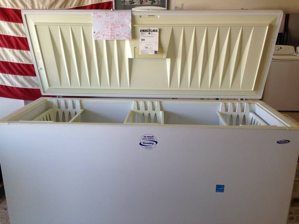 A large white freezer with the lid open