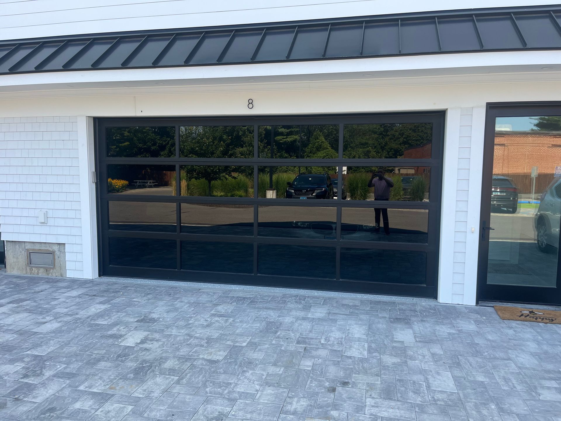 Garage door with black frame and windows, number 
