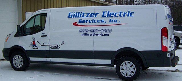 A white van from gillitzer electric services inc. is parked in the snow