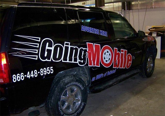A black van with going mobile written on it