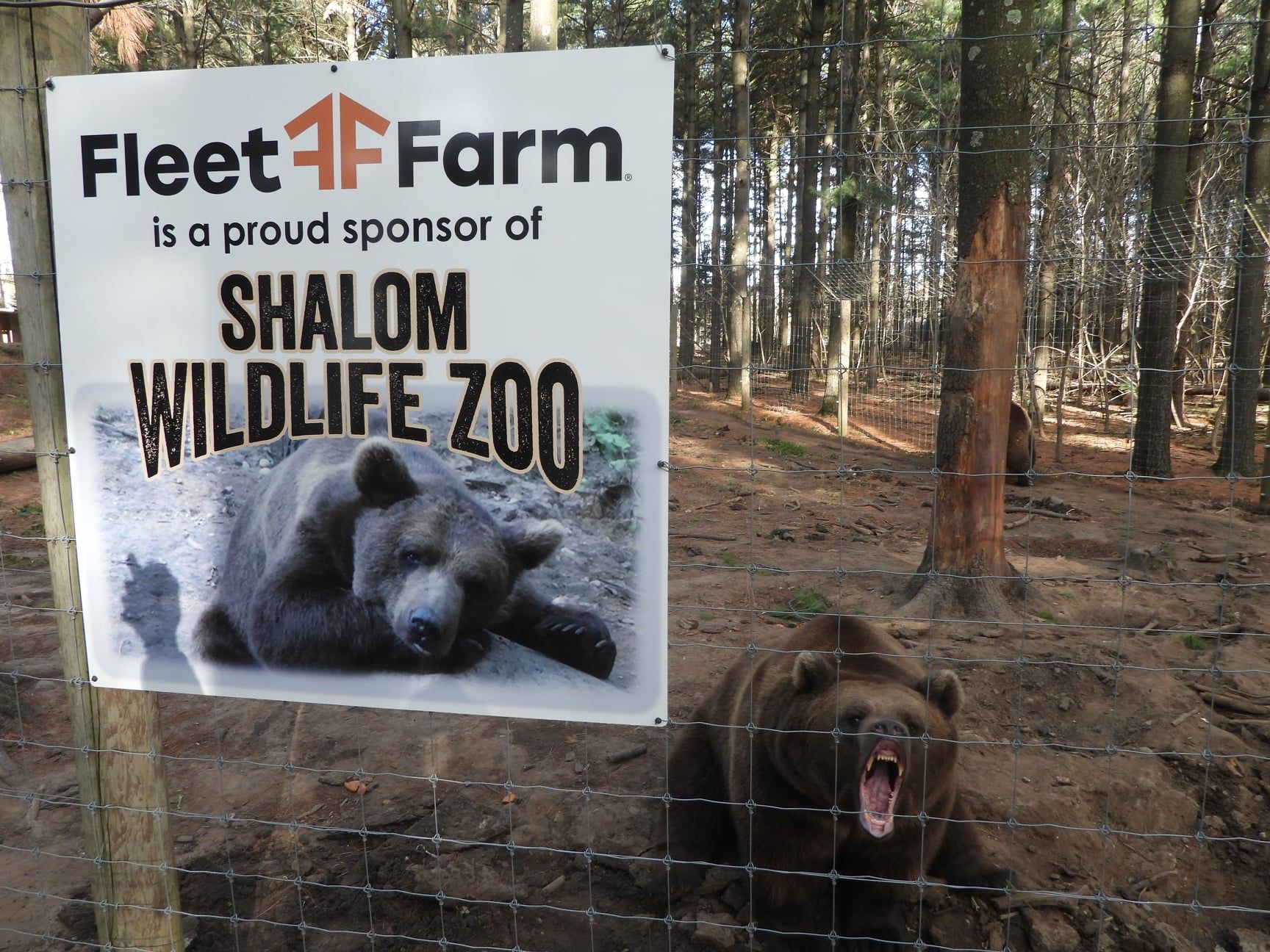 A sign that says fleet farm is a proud sponsor of shalom wildlife zoo